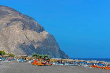 Wall Mural - A view along the beach at Perissa, Santorini in summertime