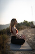 © carlos - woman doing yoga exercise outdoors