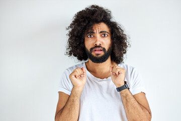 scared frightened male look at camera, guy of arabic appearance in casual white t-short