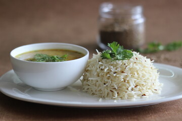 Wall Mural - Jeera rice served with dal fry, a popular north Indian food