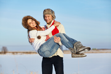 happy couple in love in the winter outdoors