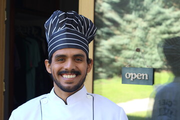 Ethnic chef at business entrance 