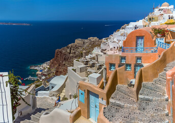 Wall Mural - Steps lead down from the village of Oia, Santorini towards Amoudi Bay in summertime