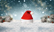 © Djordje - Santa hat isolated in snow with christmas decoration.