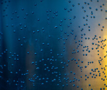 Macro Of Water Droplets In A Blue Bottle 