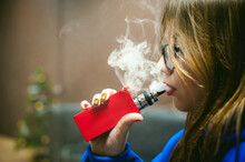 Close-up Of Young Woman Smoking Electronic Cigarette