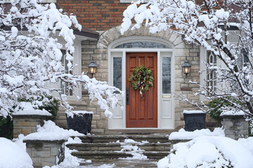 Wall Mural - front door of house with snow covered trees