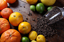 Directly Above Shot Of Fruits By Black Peppercorns On Table