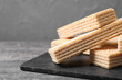 © New Africa - Delicious cream wafers on grey table, closeup. Space for text