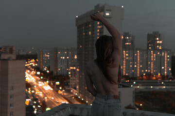 
naked girl on the roof at night