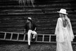 © shunevich - Stylish couple posing near the house, wearing a hats, handsome man and beautiful woman sit on the stairs, loving husband spend time with adorable wife, togetherness concept