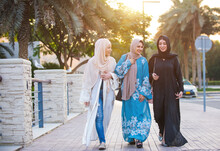 Three Women Friends Going Out In Dubai. Girls Wearing The United Arab Emirates Traditional Abaya