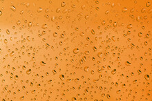 Full Frame Shot Of Wet Glass Against Orange Background