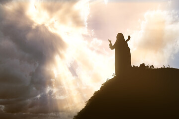 Silhouette of Jesus Christ praying to god