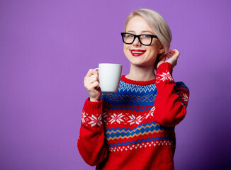 Wall Mural - Beautiful woman in Christmas sweater with cup of coffee