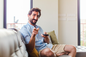 Wall Mural - bearded man pointing at camera with a satisfied, confident, friendly smile, choosing you