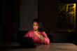 © IndiaPix - Woman working on laptop in office late in the evening
