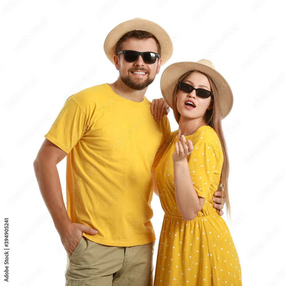 Young couple with stylish sunglasses on white background