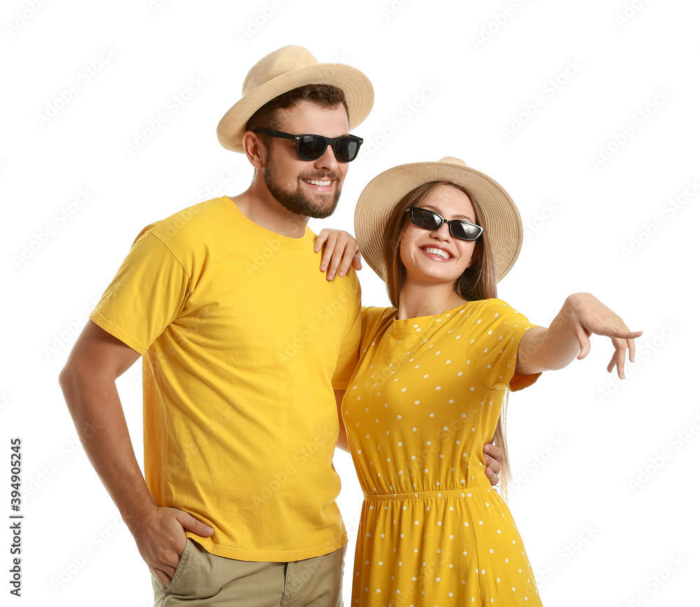 Young couple with stylish sunglasses on white background