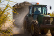 © SuperStock - Tractor pulling load of cut sugarcane through sugarcane field