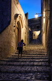 Fototapeta Uliczki -  Typical cobbled stairs in a side street alleyway iin the Sassi di Matera a historic district in the city of Matera. Basilicata. Italy