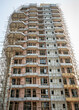 © SuperStock - Modern highrise building under construction surrounded by bamboo scaffolding