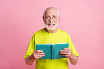 Sticker - Portrait of optimistic pensioner read copybook wear spectacles green color t-shirt isolated on pastel pink color background