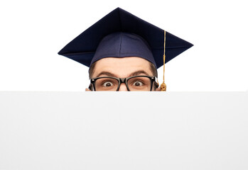 Poster - education, graduation and people concept - male graduate student or bachelor in mortarboard and glasses hiding behind white board