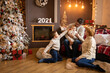 © dtatiana - Family near Christmas tree in modern decorated home, Happy New year 2021