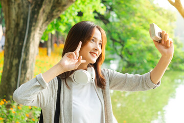 Wall Mural - Young girl taking selfie photo during her trip to Hanoi