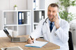 © Prostock-studio - Doctor talking on smart phone with patient, writing notes
