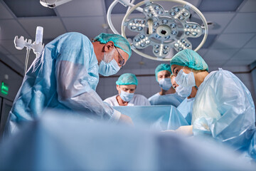 operating room caucasian team of professional surgeons and nurses working together, group of confident doctors suture wound after successful surgery