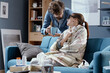 © StockPhotoPro - Husband taking care of his sick wife at home