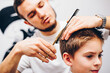 © stenkovlad - Hairdresser barbershop parihopher strechot small boy sitting on a chair