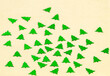 © ImageSine - Christmas modern composition. green christmas tree decorations, confetti on yellow cream background. copy space
