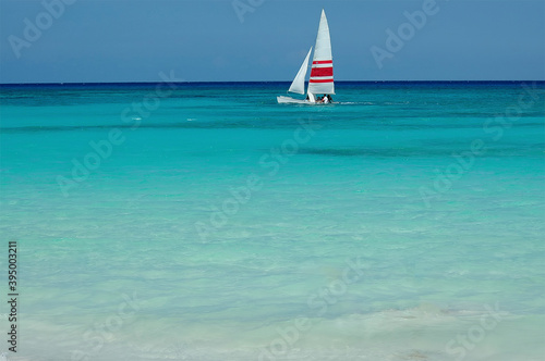 Cuadros en Lienzo A Hobie cat surfs near a tropical beach in Playa del Carmen, Mexico
