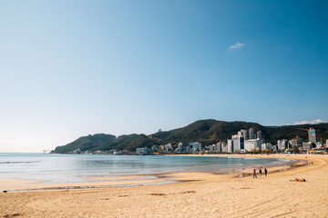 Canvas Print - Songjeong beach with modern buildings in Busan, Korea