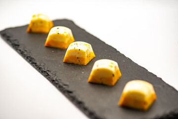 Poster - Author's sweets for a holiday, wedding, birthday, anniversary. Yellow candies on a white background in the studio.