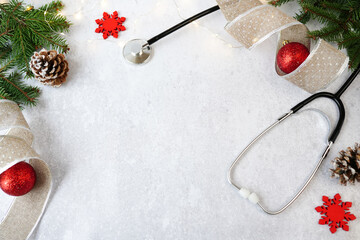 medical christmas and new year. stethoscope and red christmas decorations on white background with c