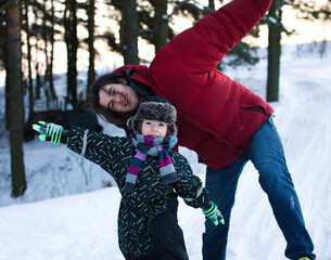 young happy father with his son little cute boy outside in winter park, lifestyle people concept