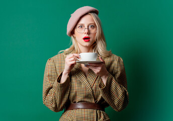 Poster - beautiful woman in style jacket and hat with cup