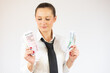 © Danko - Photo of pretty cheerful business woman standing isolated over white background holding money.