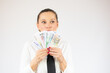 © Danko - Photo of pretty cheerful business woman standing isolated over white background holding money.