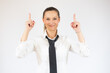 © Danko - Smiling business woman pointing up and looking at the camera over white background
