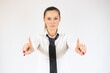 © Danko - Smiling business woman pointing up and looking at the camera over white background
