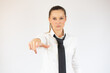 © Danko - Business woman pointing to the camera serious over white background.