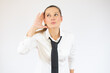 © Danko - Young business woman over isolated white background listening to something by putting hand on the ear