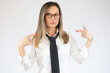 © Danko - Surprised young beautiful businesswoman pointing fingers at herself over white background.