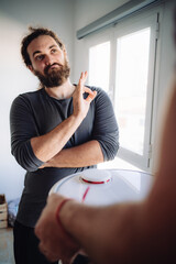 Bearded man react positively about a smart robot showed by his friend