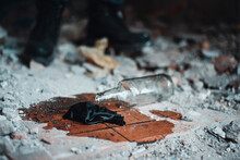 Broken Molotov Cocktail On The Floor Of Abandoned Building Near The Legs Of Soldier In Heavy Boots